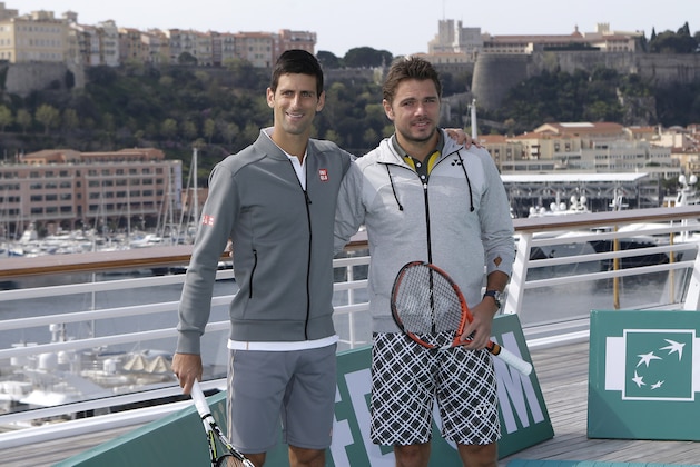 Stanislas Wawrinka of Switzerland, right, and Novak Djokovic of Serbia pose for photographers after an exhibition match on the roof of Monaco yacht club, in Monaco, Saturday, April 11, 2015, during the Monte Carlo Tennis Masters tournament. (AP Photo/Lionel Cironneau)