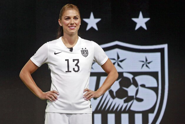 FILE - In this April 22, 2015, file photo, United States forward Alex Morgan poses in the new black and white home uniform for the U.S. women's World Cup soccer team during a news conference in Los Angeles. Morgan’s star rose quickly following her performance in Germany four years ago, when - as the youngest player on the U.S. World Cup team - she became a super sub with a goal and an assist in the final match against Japan. Now she’s a savvy veteran, handling her fame with aplomb as she prepares for her World Cup sequel. (AP Photo/Nick Ut, File)