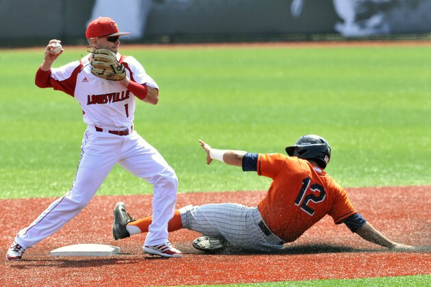 Cal State Fullerton's Jerrod Bravo, right, attempts to break up the double play throw by Louisville's Sutton Whiting during the second inning in the Louisville Super Regional of the NCAA college baseball tournament, Saturday, June 6, 2015, in Louisville Ky.  (AP Photo/Timothy D. Easley)