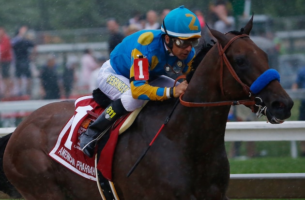 May 16, 2015; Baltimore, MD, USA; Victor Espinoza aboard American Pharoah leads the pack out of turn four during the 140th Preakness Stakes at Pimlico Race Course. Mandatory Credit: Geoff Burke-USA TODAY Sports