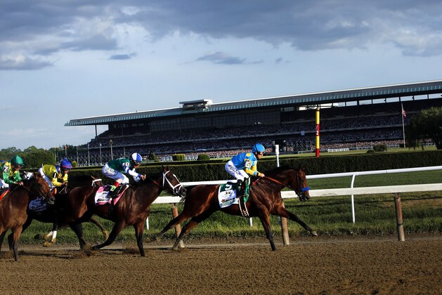 American Pharoah (5) leads the field entering turn three on the way to a Triple Crown victory during the 147th running of the Belmont Stakes horse race at Belmont Park, Saturday, June 8, 2015, in Elmont, N.Y. (AP Photo/Jason DeCrow)