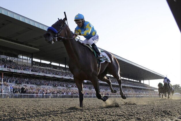 Victor Espinoza reacts after crossing the finish line with American Pharoah to win the 147th running of the Belmont Stakes horse race at Belmont Park, Saturday, June 6, 2015, in Elmont, N.Y. American Pharoah is the first horse to win the Triple Crown since Affirmed won it in 1978.  (AP Photo/Julio Cortez)