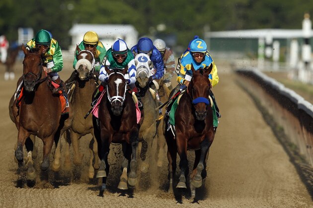 American Pharoah (5), far right, leads Materiality (8) and the rest of the field down the back stretch on the way to a Triple Crown victory during the 147th running of the Belmont Stakes horse race at Belmont Park, Saturday, June 6, 2015, in Elmont, N.Y. (AP Photo/Jason DeCrow)