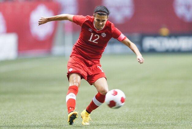 Oct 28, 2014; Vancouver, British Columbia, Canada; Canada forward Christine Sinclair (12) makes a cross against Japan during the first half at BC Place. Mandatory Credit: Joe Nicholson-USA TODAY Sports