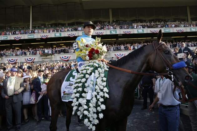 Jockey Victor Espinoza parades American Pharoah through the Winner's Circle after winning the 147th running of the Belmont Stakes horse race at Belmont Park, Saturday, June 6, 2015, in Elmont, N.Y. American Pharoah is the first horse to win the Triple Crown since Affirmed won it in 1978.(AP Photo/Seth Wenig)