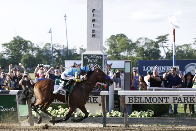 American Pharoah (5) with Victor Espinoza up crosses the finish line to win the 147th running of the Belmont Stakes horse race at Belmont Park, Saturday, June 6, 2015, in Elmont, N.Y. American Pharoah is the first horse to win the Triple Crown since Affirmed won it in 1978. (AP Photo/Seth Wenig)