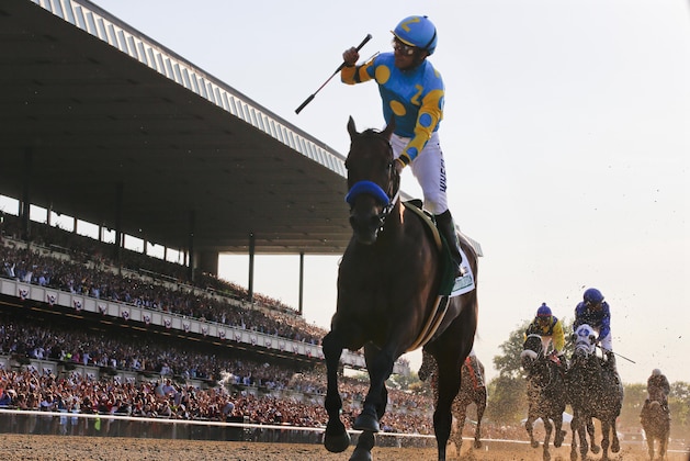 Victor Espinoza reacts after crossing the finish line with American Pharoah (5) to win the 147th running of the Belmont Stakes horse race at Belmont Park, Saturday, June 6, 2015, in Elmont, N.Y. American Pharoah is the first horse to win the Triple Crown since Affirmed won it in 1978.  (AP Photo/Julio Cortez)
