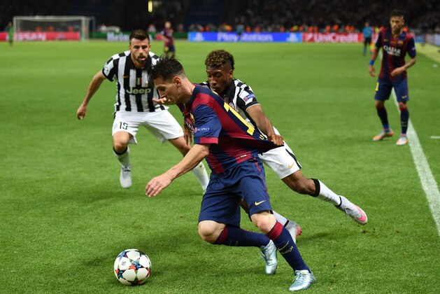 BERLIN, GERMANY - JUNE 06: Lionel Messi of Barcelona is held by Kingsley Coman of Juventus during the UEFA Champions League Final between Juventus and FC Barcelona at Olympiastadion on June 6, 2015 in Berlin, Germany.  (Photo by Matthias Hangst/Getty Images)