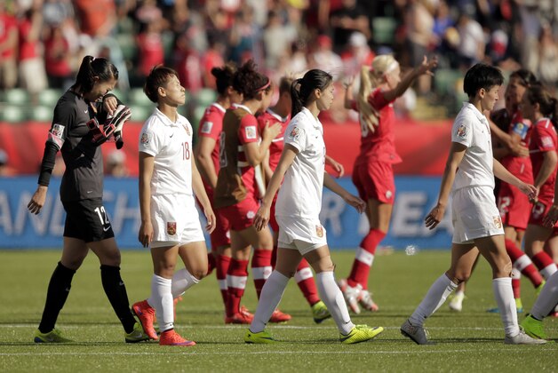 Jun 6, 2015; Edmonton, Alberta, CAN; China goalkeeper Wang Fei (12) walks off as Canada celebrates after a Group A soccer match in the 2015 women's World Cup at Commonwealth Stadium. Canada won 1-0. Mandatory Credit: Erich Schlegel-USA TODAY Sports