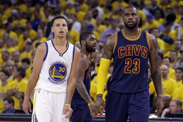 Golden State Warriors guard Stephen Curry (30) and Cleveland Cavaliers forward LeBron James (23) walk on the floor during the second half of Game 1 of basketball's NBA Finals in Oakland, Calif., Thursday, June 4, 2015. (AP Photo/Ben Margot)