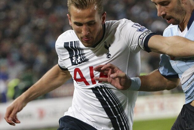 Tottenham Hotspur player Harry Kane, left, and Sydney F.C player Nikola Petkovic battle for the ball during their friendly match in Sydney, Australia, Saturday, May 30, 2015. (AP Photo/Rob Griffith)