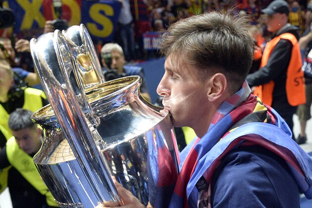Barcelona's Lionel Messi kisses the trophy after his team won 3-1 the Champions League final soccer match between Juventus Turin and FC Barcelona at the Olympic stadium in Berlin Saturday, June 6, 2015. (AP Photo/Martin Meissner)