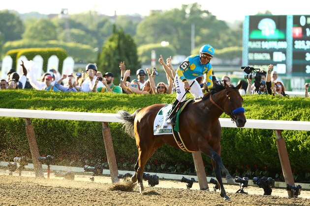ELMONT, NY - JUNE 06:  Victor Espinoza, celebrates atop American Pharoah #5, after winning the 147th running of the Belmont Stakes at Belmont Park on June 6, 2015 in Elmont, New York. With the wins American Pharoah becomes the first horse to win the Triple Crown in 37 years.  (Photo by Al Bello/Getty Images)