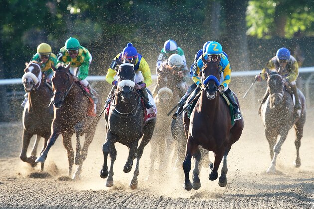 ELMONT, NY - JUNE 06:  American Pharoah #5, ridden by Victor Espinoza, leads the field out of the fourth turn during the 147th running of the Belmont Stakes at Belmont Park on June 6, 2015 in Elmont, New York.  (Photo by Elsa/Getty Images)