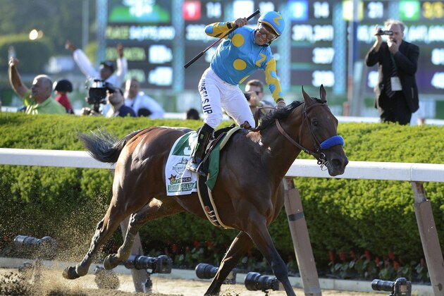 Victor Espinoza reacts after crossing the finish line with American Pharoah (5) to win the 147th running of the Belmont Stakes horse race at Belmont Park, Saturday, June 6, 2015, in Elmont, N.Y.  American Pharoah is the first horse to win the Triple Crown since Affirmed won it in 1978.(AP Photo/Bill Kostroun)