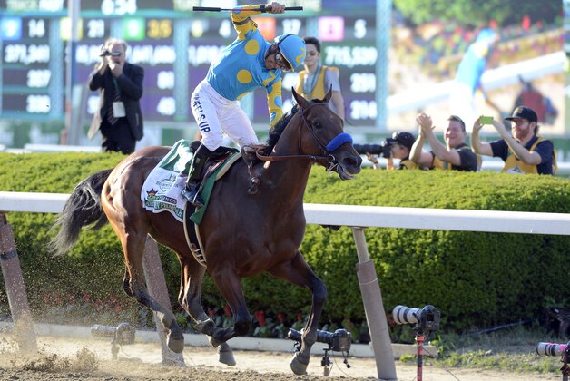 Victor Espinoza reacts after guiding American Pharoah to win the 147th running of the Belmont Stakes horse race at Belmont Park, Saturday, June 6, 2015, in Elmont, N.Y. American Pharoah became the first horse since Affirmed in 1978 to win the Triple Crown. (AP Photo/Bill Kostroun)