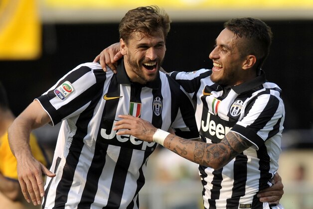 Juventus' Roberto Pereyra, right, celebrates with his teammate Fernando Llorente after scoring against Verona during their Italian Serie A soccer match at Bentegodi stadium in Verona, Italy, Saturday, May 30, 2015. (AP Photo/Marco Vasini)