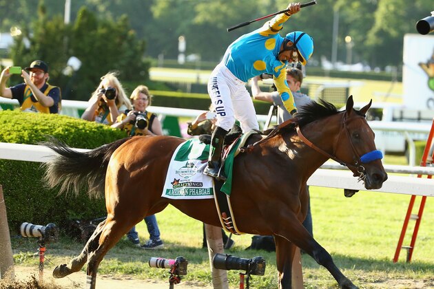 ELMONT, NY - JUNE 06:  Victor Espinoza celebrates atop American Pharoah #5 after winning the 147th running of the Belmont Stakes becoming the first horse in 37 years to win the Triple Crown at Belmont Park on June 6, 2015 in Elmont, New York.  (Photo by Al Bello/Getty Images)