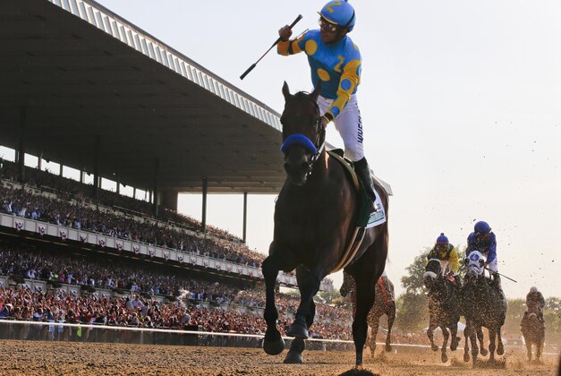 Victor Espinoza reacts after crossing the finish line with American Pharoah (5) to win the 147th running of the Belmont Stakes horse race at Belmont Park, Saturday, June 6, 2015, in Elmont, N.Y. American Pharoah is the first horse to win the Triple Crown since Affirmed won it in 1978.  (AP Photo/Julio Cortez)
