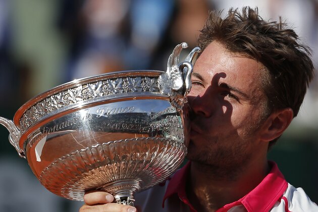 Switzerland's Stan Wawrinka kisses the trophy after winning the men's final of the French Open tennis tournament in four sets, 4-6, 6-4, 6-3, 6-4, against Serbia's Novak Djokovic at the Roland Garros stadium, in Paris, France, Sunday, June 7, 2015. (AP Photo/Michel Euler)