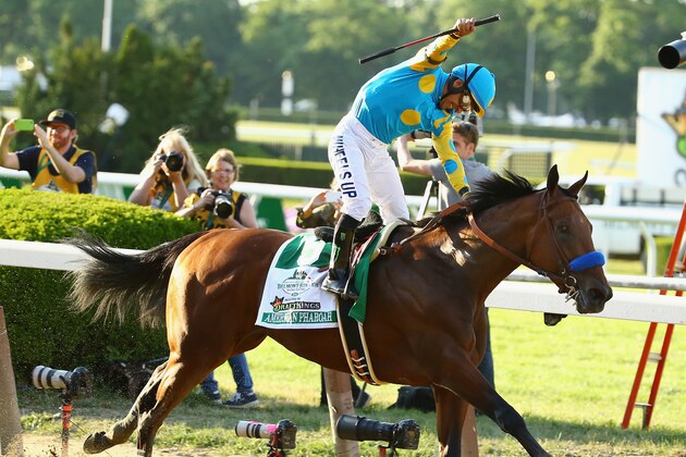 ELMONT, NY - JUNE 06:  Victor Espinoza celebrates atop American Pharoah #5 after winning the 147th running of the Belmont Stakes becoming the first horse in 37 years to win the Triple Crown at Belmont Park on June 6, 2015 in Elmont, New York.  (Photo by Al Bello/Getty Images)