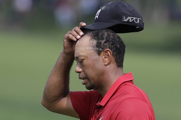 Tiger Woods walks off the 18th green following his final round of the Memorial golf tournament Sunday, June 7, 2015, in Dublin, Ohio. (AP Photo/Darron Cummings)