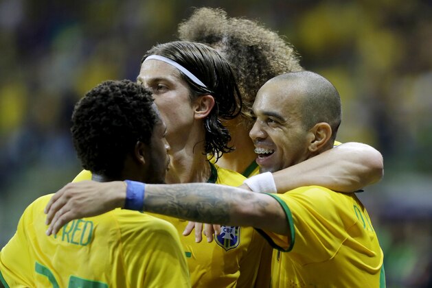 Brazil's Diego Tardelli, right, celebrates with his teammates after scoring against Mexico during a friendly soccer match in Sao Paulo, Brazil, Sunday, June 7, 2015. Brazil and Mexico are preparing for the Copa America which begins Thursday in Chile. (AP Photo/Nelson Antoine)