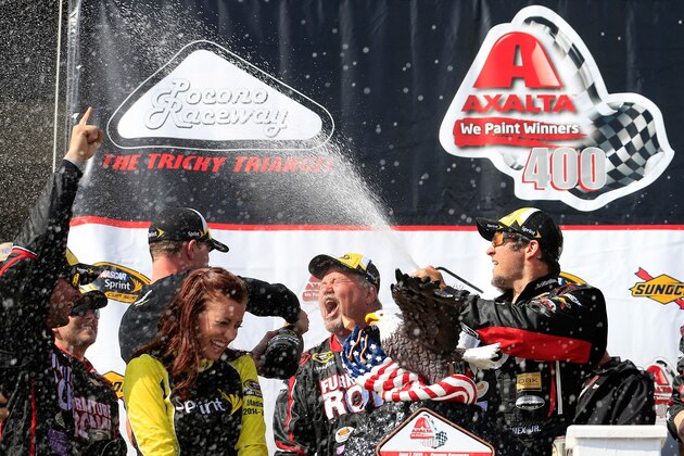 LONG POND, PA - JUNE 07:  Martin Truex Jr., driver of the #78 Furniture Row/Visser Precision Chevrolet, celebrates in Victory Lane after winning the NASCAR Sprint Cup Series Axalta 'We Paint Winners' 400 at Pocono Raceway on June 7, 2015 in Long Pond, Pennsylvania.  (Photo by Chris Trotman/Getty Images)