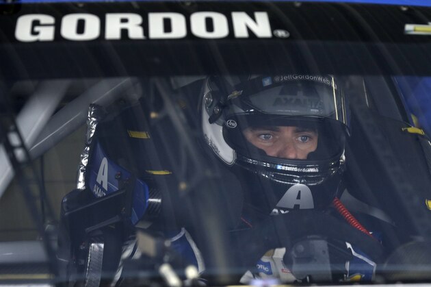 Jeff Gordon (24) waits in his race car at Pocono Raceway during practice for Sunday's NASCAR Sprint Cup Series auto race in Long Pond, Pa., Saturday, June 6, 2015. (AP Photo/Mel Evans)