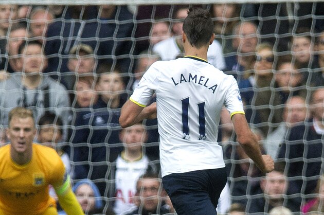 Tottenham Hotspurs's Paulinho, second left, and Erik Lamela, right, try to score past Manchester City's Joe Hart, center, during the English Premier League soccer match between Tottenham Hotspurs and Manchester City, at White Hart Lane Stadium in London, Sunday, May 3, 2015. (AP Photo/Bogdan Maran)