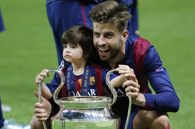 Barcelona's Gerard Pique celebrates with his son Milan after the Champions League final soccer match between Juventus Turin and FC Barcelona at the Olympic stadium in Berlin Saturday, June 6, 2015. Barcelona won the match 3-1.  (AP Photo/Frank Augstein)