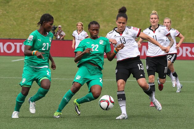 OTTAWA, ON - JUNE 7: Celia Sasic #13 of Germany vies for the ball against Sophie Aguie #21 and Raymonde Kacou #22 of Cote d'Ivoire during the FIFA Women's World Cup Canada 2015 Group B match between Germany and Cote d'Ivoire at Lansdowne Stadium on June 7, 2015 in Ottawa, Canada. (Photo by Andre Ringuette/Getty Images)