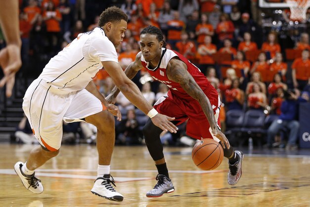 Jan 7, 2015; Charlottesville, VA, USA; North Carolina State Wolfpack guard Anthony Barber (12) dribbles the ball as Virginia Cavaliers guard Justin Anderson (1) defends in the first half at John Paul Jones Arena. Mandatory Credit: Amber Searls-USA TODAY Sports