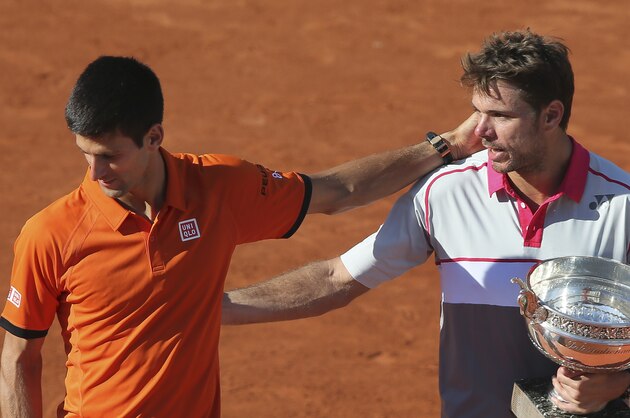French Open winner Stan Wawrinka, right, looks at Serbia's Novak Djokovic as he leaves the podium after the men's final of the French Open tennis tournament at the Roland Garros stadium, in Paris, France, Sunday, June 7, 2015. Wawrinka won in in four sets, 4-6, 6-4, 6-3, 6-4. (AP Photo/David Vincent)