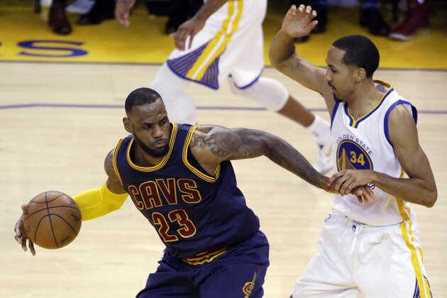 Cleveland Cavaliers forward LeBron James (23) is guarded by Golden State Warriors guard Shaun Livingston during the first half of Game 2 of basketball's NBA Finals in Oakland, Calif., Sunday, June 7, 2015. (AP Photo/Eric Risberg)