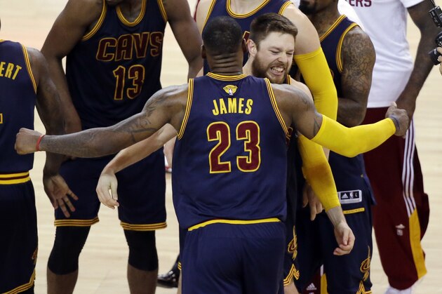 Cleveland Cavaliers guard Matthew Dellavedova, right, hugs forward LeBron James (23) after the end of the overtime period of Game 2 of basketball's NBA Finals against the Golden State Warriors in Oakland, Calif., Sunday, June 7, 2015. The Cavaliers won 95-93 in overtime. (AP Photo/Eric Risberg)