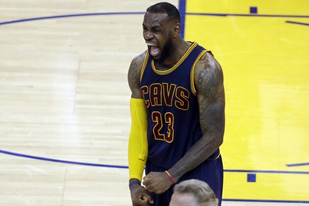 Cleveland Cavaliers forward LeBron James (23) celebrates after end of the overtime period of Game 2 of basketball's NBA Finals against the Golden State Warriors in Oakland, Calif., Sunday, June 7, 2015. The Cavaliers won 95-93 in overtime. (AP Photo/Eric Risberg)