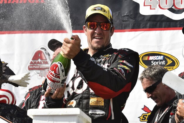Martin Truex Jr. celebrates in Victory Lane at Pocono Raceway after winning a NASCAR Sprint Cup Series auto race at Pocono Raceway in Long Pond, Pa., Sunday, June 7, 2015. (AP Photo/Derik Hamilton)