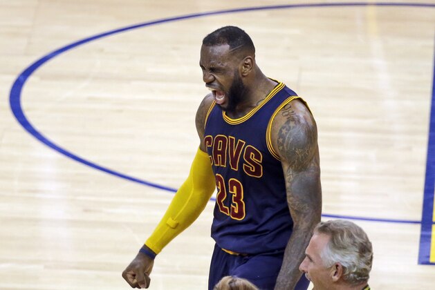 Cleveland Cavaliers forward LeBron James (23) celebrates at the end of the overtime period of Game 2 of basketball's NBA Finals against the Golden State Warriors in Oakland, Calif., Sunday, June 7, 2015. The Cavaliers won 95-93 in overtime. (AP Photo/Eric Risberg)