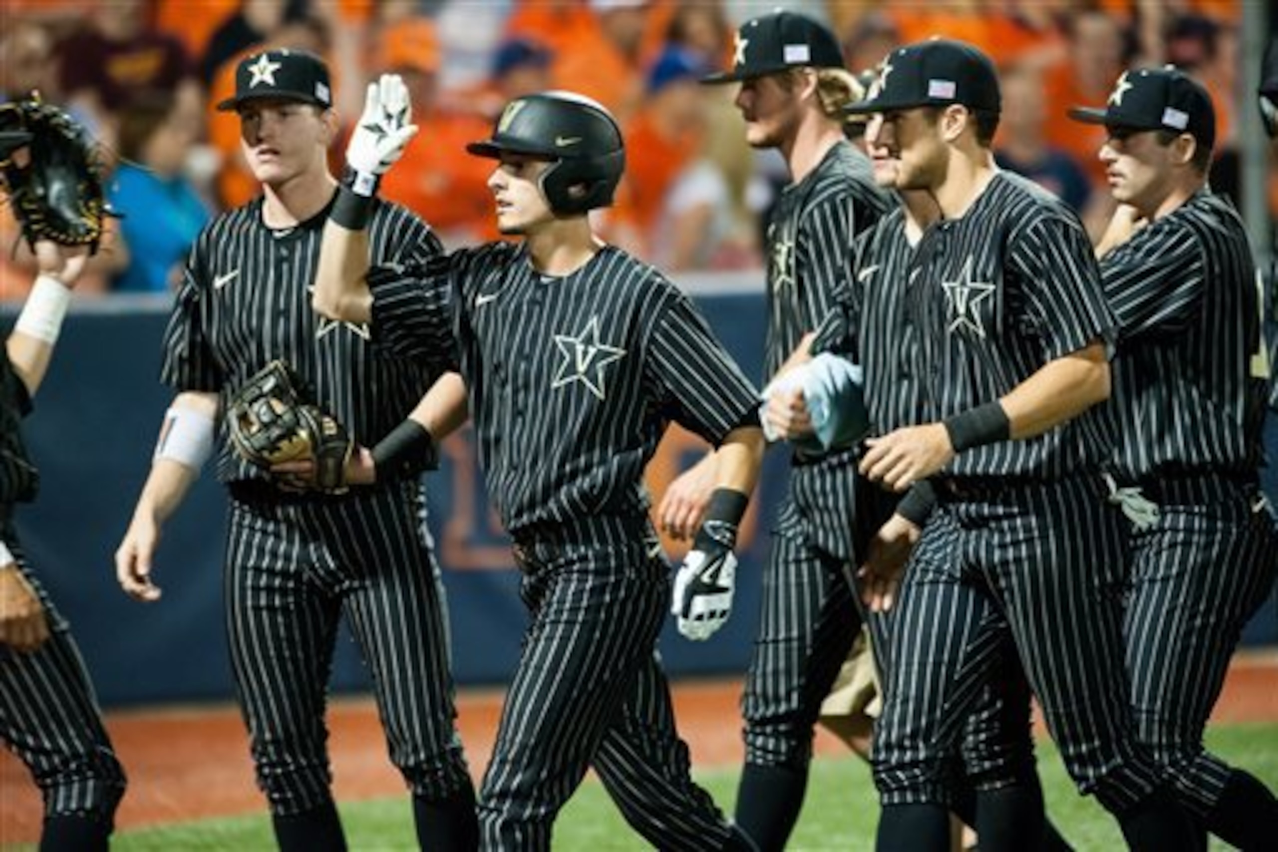 CORRECTS SCORE TO 13-0, NOT 14-0 - Players greet Vanderbilt infielder Tyler Campbell (2) after his home run against Illinois during the seventh inning of an NCAA college baseball tournament super regional game, Saturday, June 6, 2015, in Champaign, Ill. Vanderbilt defeated Illinois 13-0. (AP Photo/Bradley Leeb) CORRECTS SCORE TO 13-0, NOT 14-0 - Players greet Vanderbilt infielder Tyler Campbell (2) after his home run against Illinois during the seventh inning of an NCAA college baseball tournament super regional game, Saturday, June 6, 2015, in Champaign, Ill. Vanderbilt defeated Illinois 13-0. (AP Photo/Bradley Leeb)