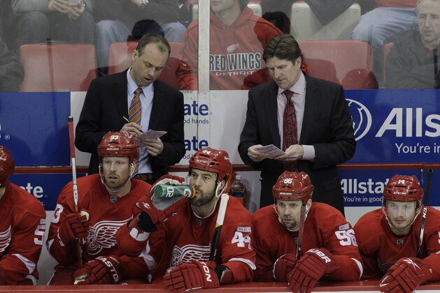 Detroit Red Wings assistant coache Jeff Blashill, left, looks over notes with head coach Mike Babcock during the third period of an NHL hockey game against the Nashville Predators in Detroit, Friday, March 30, 2012. (AP Photo/Carlos Osorio)
