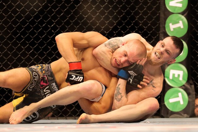 Niklas Backstrom from Sweden, right, fights Tom Niinimaki from Finland in a featherweight fight during the UFC Fight Night mixed martial arts event in Berlin, Saturday, May 31, 2014. Niklas Backstrom won the fight. (AP Photo/Markus Schreiber)