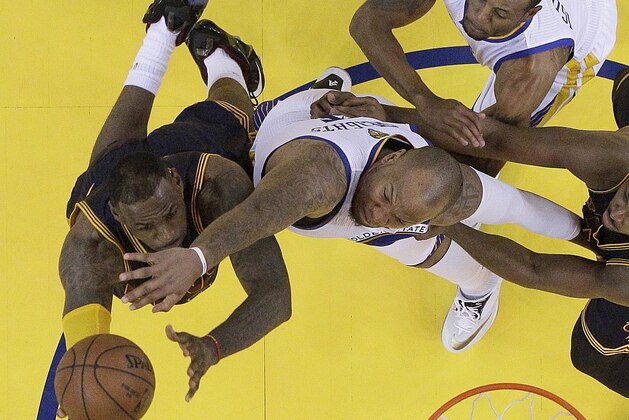 Cleveland Cavaliers forward LeBron James, left, shoots against Golden State Warriors forward Marreese Speights, center, and forward Andre Iguodala, top, during the first half of Game 2 of basketball's NBA Finals in Oakland, Calif., Sunday, June 7, 2015. The Cavaliers won 95-93 in overtime. (AP Photo/Jeff Chiu, Pool)