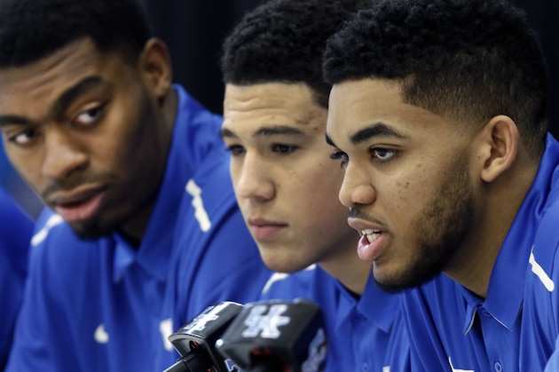 Kentucky NCAA college basketball player Karl-Anthony Towns, right, speaks while teammates, from left, Dakari Johnson and Devin Booker listen after the players announced their intent to place their names in the NBA draft during a news conference at the Joe Craft Center, Thursday, April 9, 2015, in Lexington, Ky. (AP Photo/James Crisp)