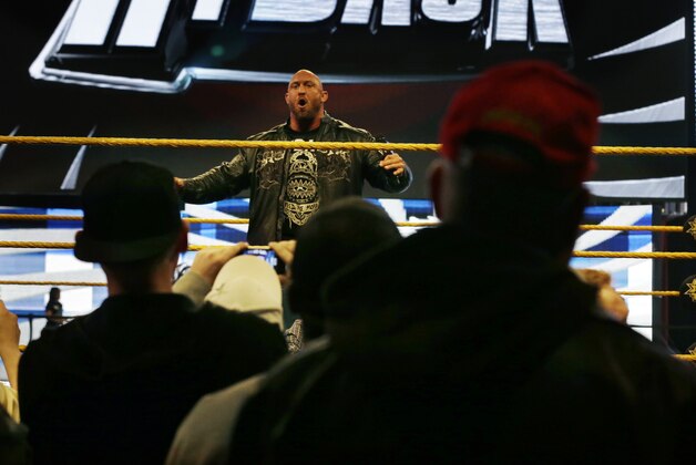 People gather ringside as they listen to professional wrestler Ryan Reeves, known as Ryback, at the Wrestlemania Axxess event Saturday, April 6, 2013, in East Rutherford, N.J., ahead of Sunday's WWE Wrestlemania 29 at MetLife stadium. (AP Photo/Mel Evans)