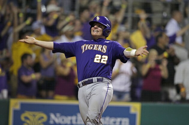 LSU's Kade Scivicque (22) reacts after scoring on a two-run RBI triple by Conner Hale during the eighth inning against Louisiana-Lafayette at the LSU Super Regional of the NCAA college baseball tournament in Baton Rouge, La., Sunday, June 7, 2015. LSU won 6-3 to advance to the College Wold Series. (AP Photo/Gerald Herbert)