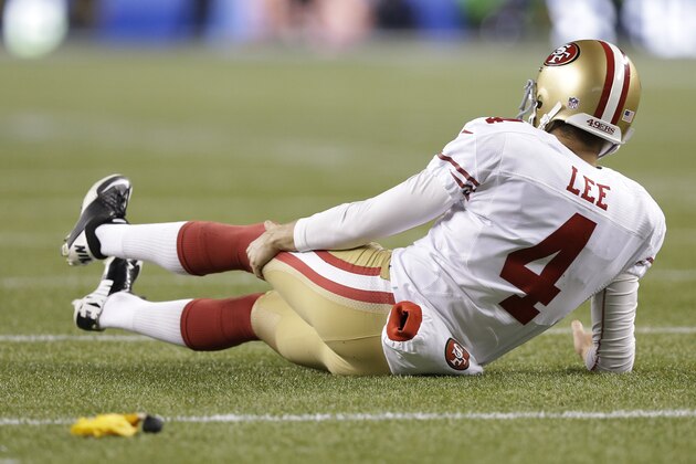 San Francisco 49ers' Andy Lee holds his leg after receiving a roughing the kicker call during the second half of the NFL football NFC Championship game against the Seattle Seahawks, Sunday, Jan. 19, 2014, in Seattle. (AP Photo/Elaine Thompson)