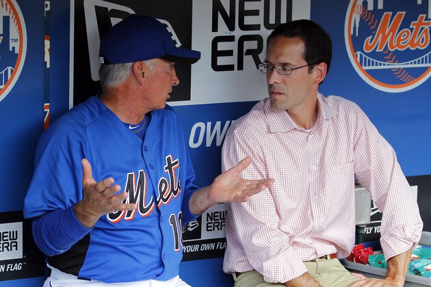 New York Mets manager Terry Collins talks with Mets VP of Player Development Paul DePodesta in the dugout before the game against the San Diego Padres in New York, Monday, Aug. 8, 2011. (AP Photo/Paul J. Bereswill)