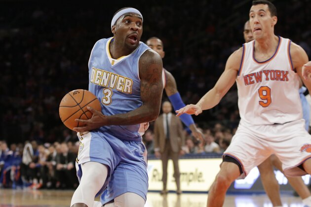 Denver Nuggets guard Ty Lawson (3) drives into the paint as New York Knicks guard Pablo Prigioni (9) and center Jason Smith (14) look on in the first half of an NBA basketball game in New York, Sunday, Nov. 16, 2014. (AP Photo/Kathy Willens)