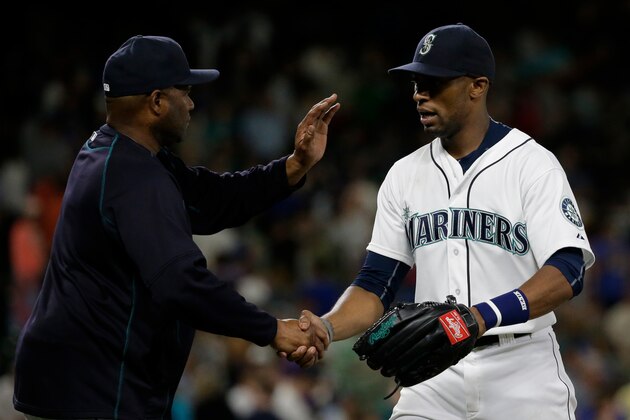 Seattle Mariners manager Lloyd McClendon, left, shakes hands with Austin Jackson, right, after a baseball game against the Tampa Bay Rays, Saturday, June 6, 2015, in Seattle. (AP Photo/Ted S. Warren)